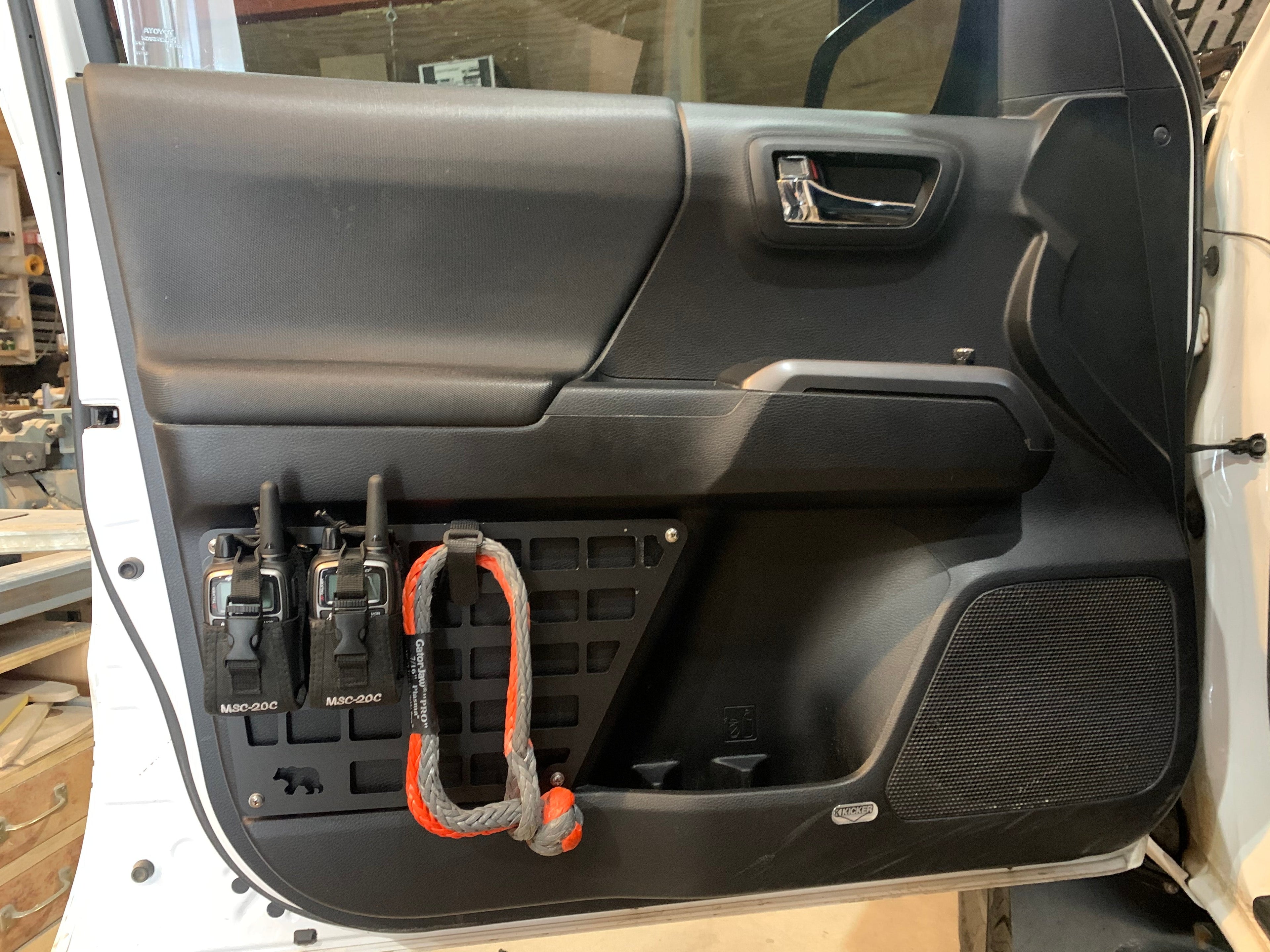 3rd Gen Tacoma door Molle panel set by New Holland Overland installed on vehicle door with mounting hardware.