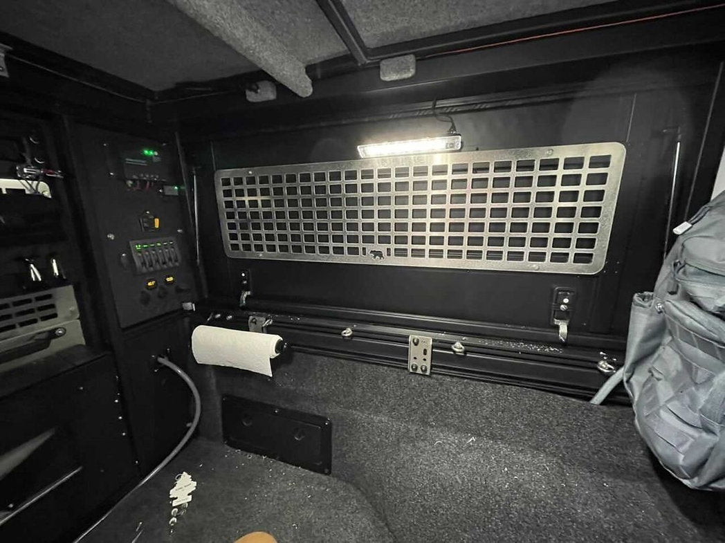 Alu-Cab Side Door Molle Panel on a vehicle door, designed for New Holland Overland trucks, with multiple attachment slots.