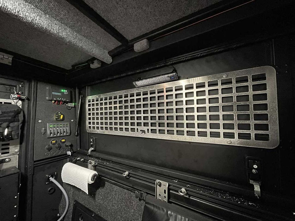 Alu-Cab Side Door Molle Panel installed on a vehicle door, featuring multiple attachment points for gear organization, by New Holland Overland.