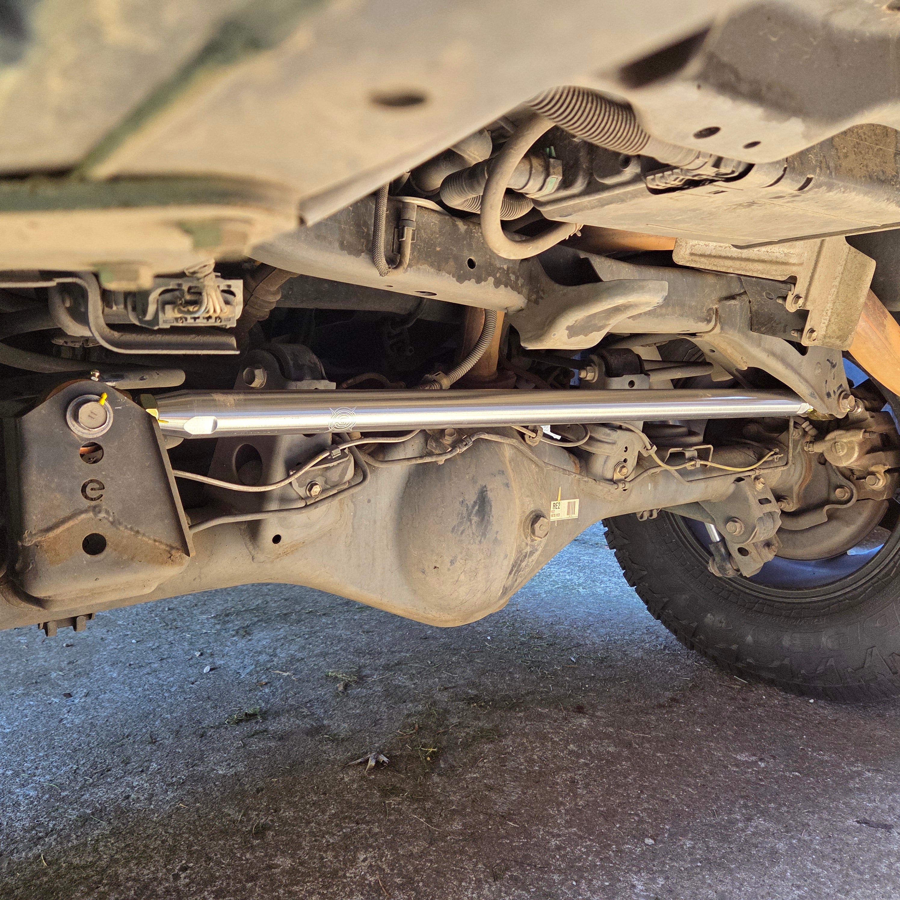 Overland Custom Design Panhard Bar for 96+ Toyota 4Runner, FJ Cruiser, and GX, shown installed on vehicle suspension.