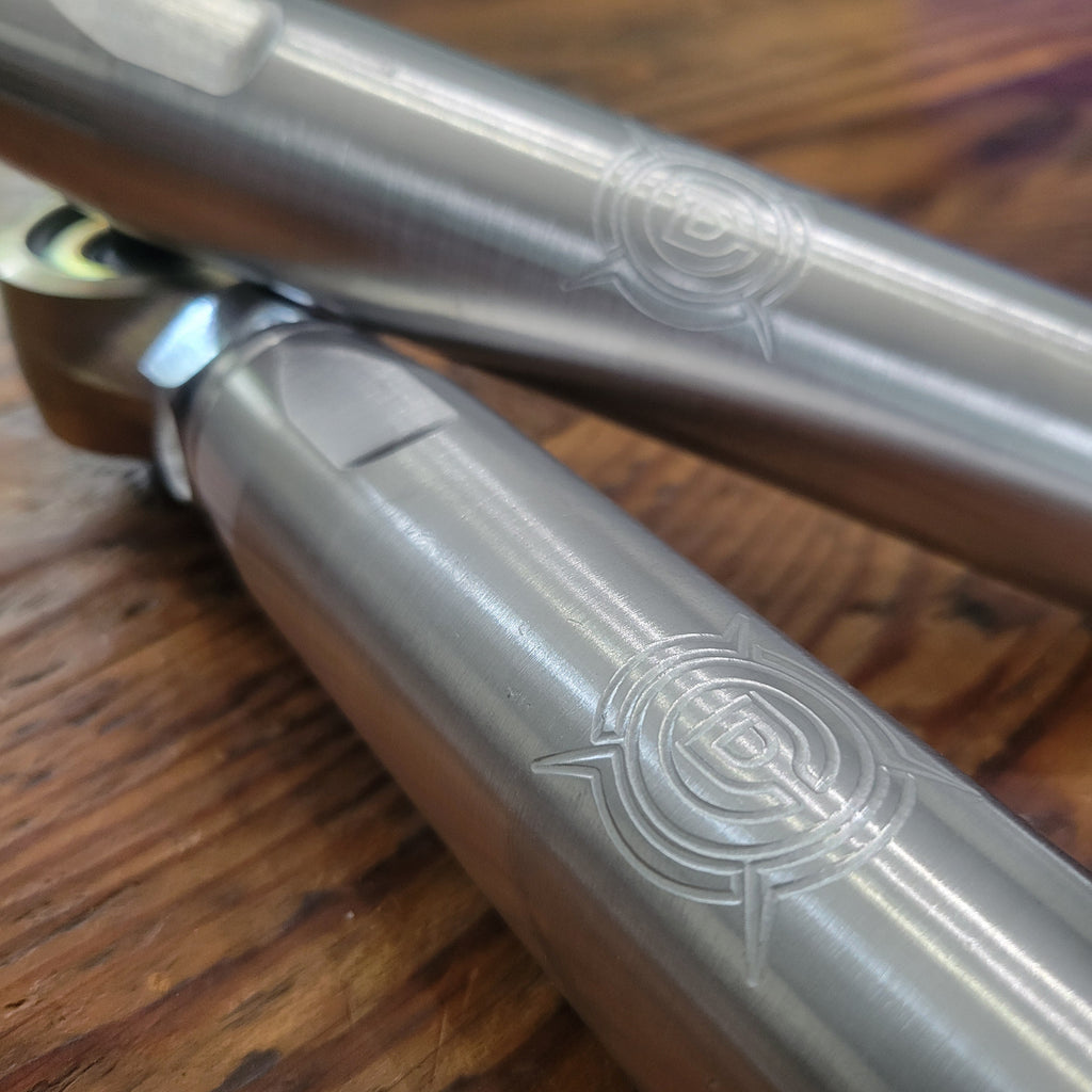 Overland Custom Design lower control arms for 3rd Gen Toyota 4Runner, showing the sturdy metal construction and mounting points.