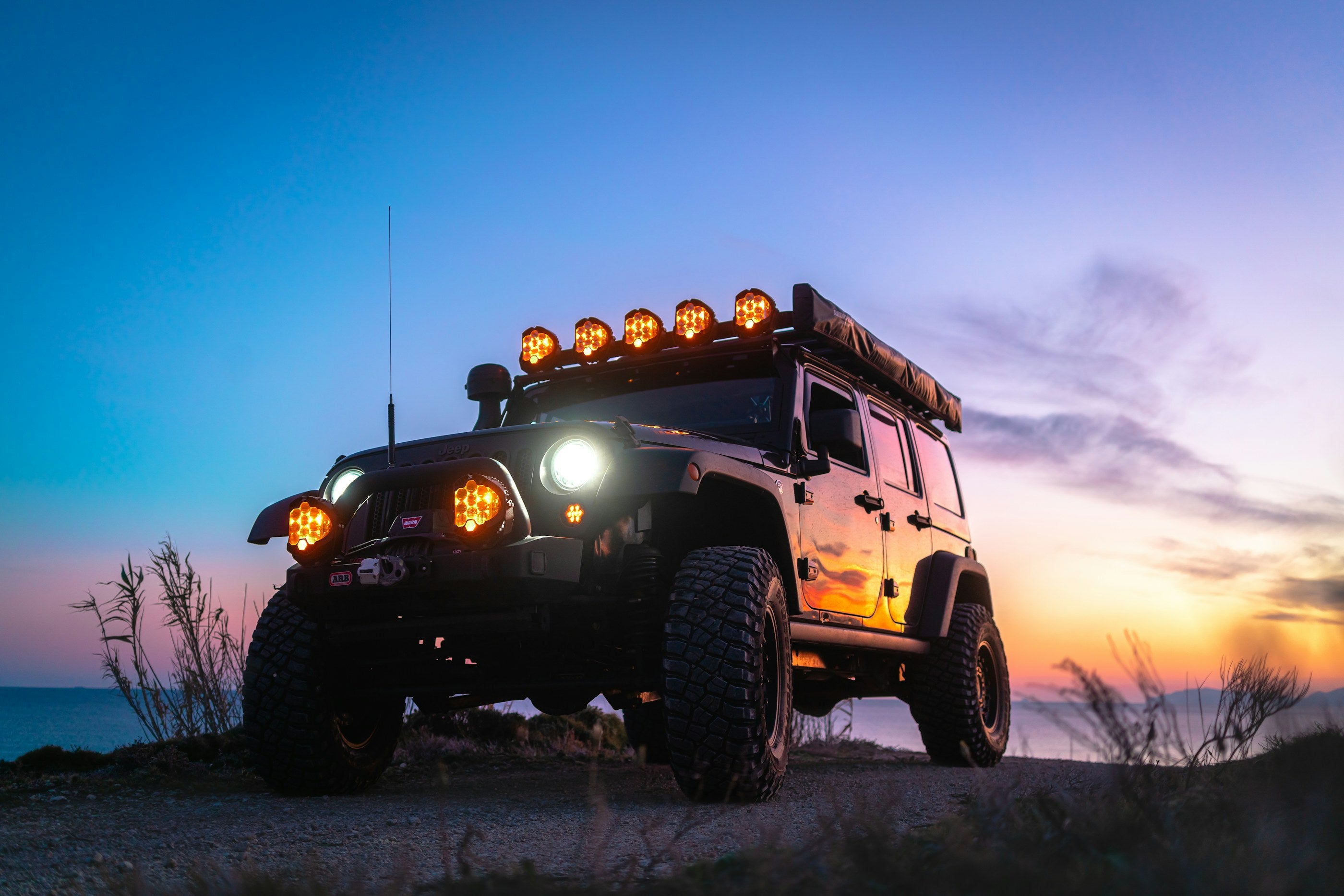 4x4 with lights on at night on the trail