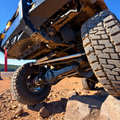 Overland Custom Design 80 Series steering linkage showing metal components and connection points for off-road vehicle steering system