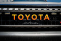 White Toyota Land Cruiser 2024+ front grille emblem overlay by StickerFab, featuring a simple, sleek emblem design.
