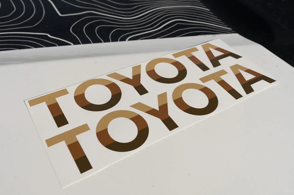 White Toyota Land Cruiser 2024+ front grille emblem overlays by StickerFab, designed for a sleek, customized look.