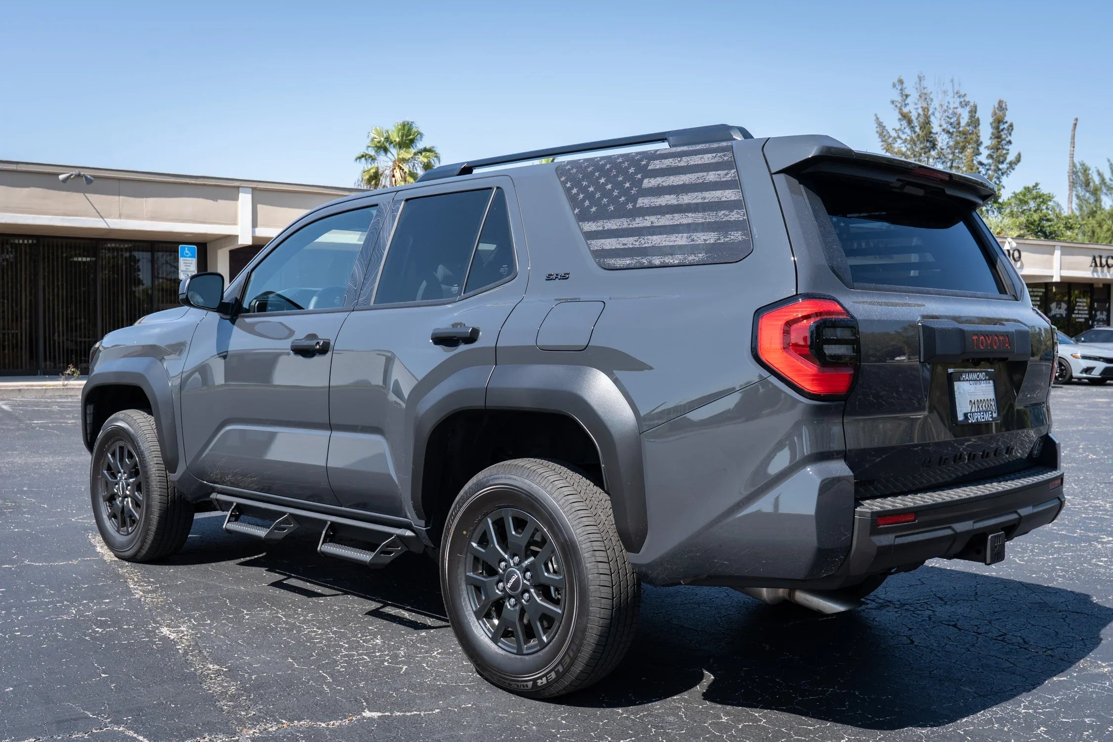 Perforated American flag rear window overlay vinyl decal for 2025+ Toyota 4Runner by StickerFab, featuring gray and black flag design