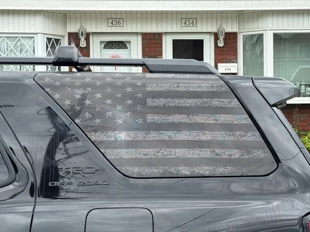 Perforated American flag rear window overlay vinyl for 2025+ Toyota 4Runner by StickerFab, exterior decal in gray carbonized design.