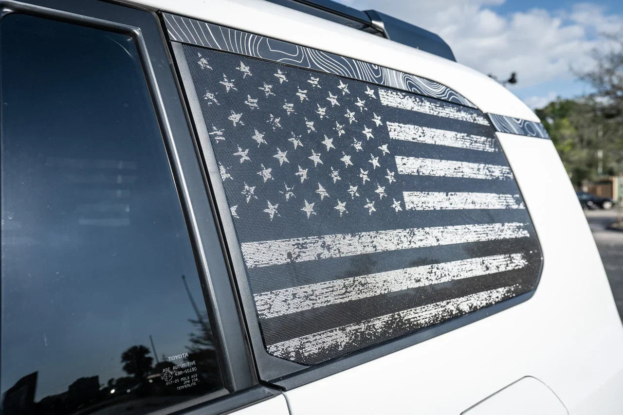 Perforated American flag rear window overlay vinyl for 2025+ Toyota 4Runner, exterior decal with gray carbonized design by StickerFab.