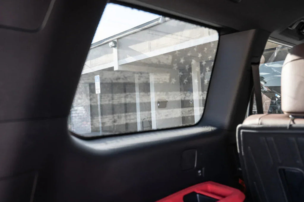 Perforated American flag rear window overlay vinyl for 2025+ Toyota 4Runner, exterior decal by StickerFab in gray carbonized finish.