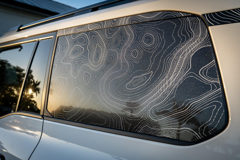 Perforated vinyl topographic rear window map overlay for 2024+ Land Cruiser, exterior customization by StickerFab in heritage blue